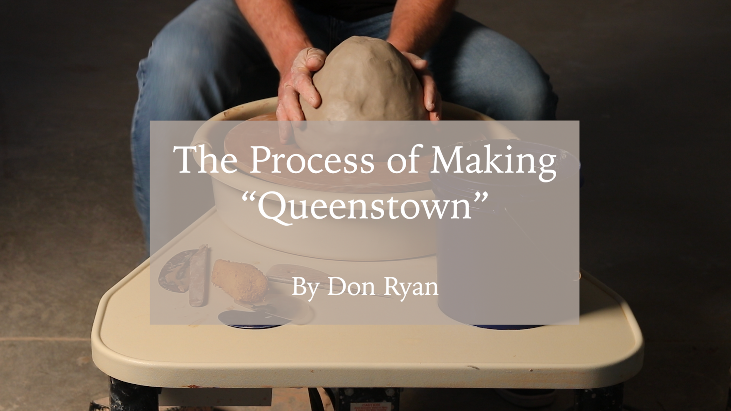 Load video: This is a video titled: &quot;The Process of Making &#39;Queenstown.&#39;&quot; Depicting the artist Don Ryan as he creates a masterful lamp from scratch. In his process he expands clay on a throwing wheel, stretches it, shapes it, adds details such as handles made from a slab and texture. It then gets bisque fired, glazed, and high fired. The video ends by showing an image of the final piece and the artists logo.