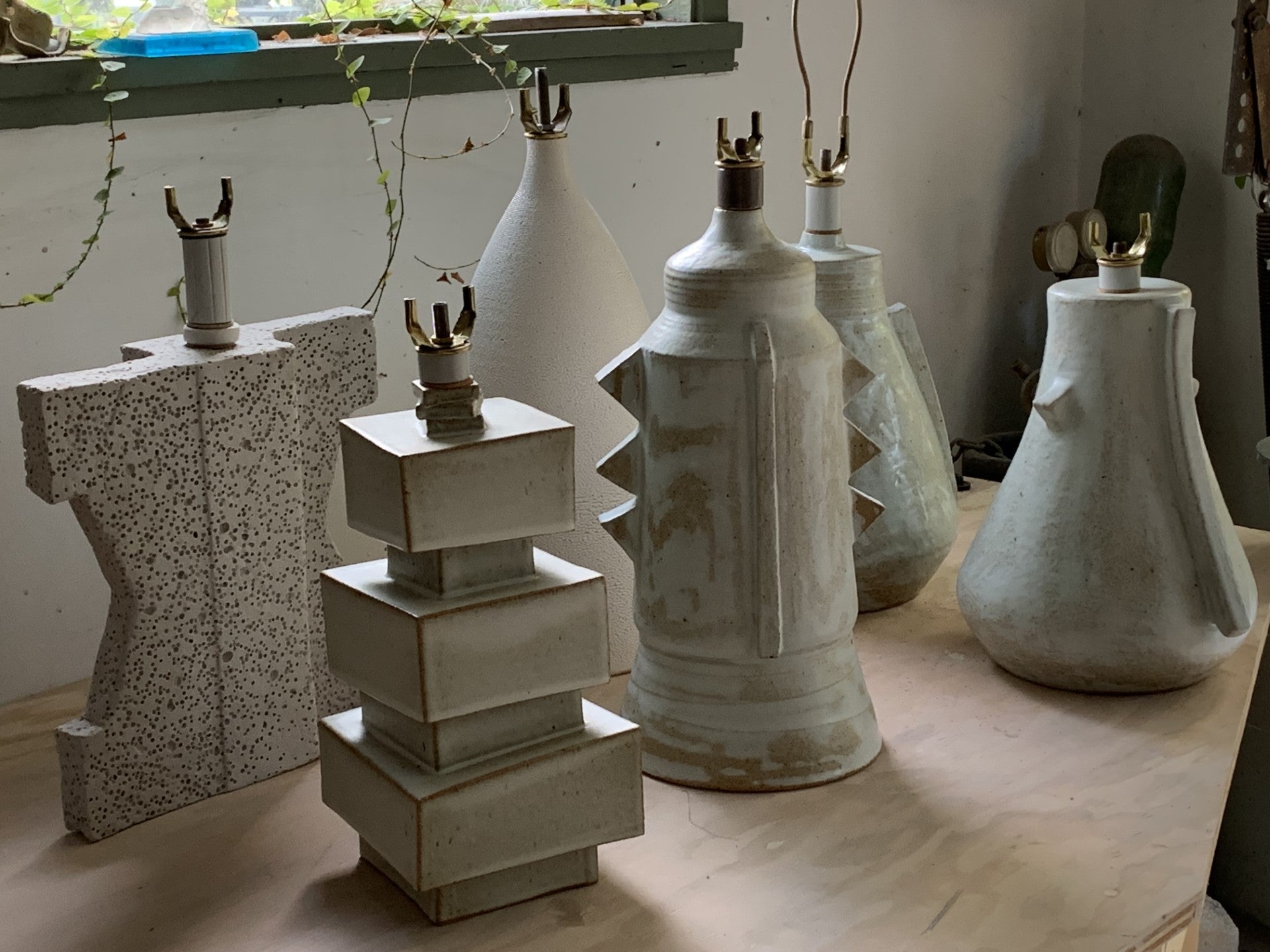 Photograph of a group of modern lamps in a studio with light coming from the window